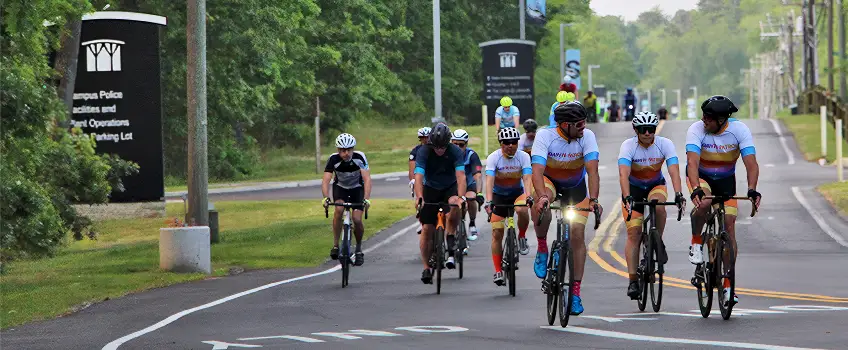 Biker riders, riding through Stockton's campus