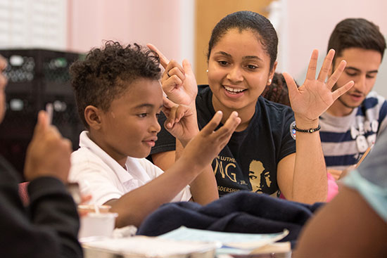 student helping school children