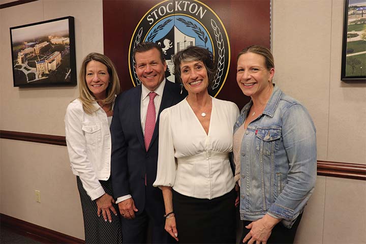 Mary Lou Galantino with her siblings in the President's Conference Room after endowing her scholarship