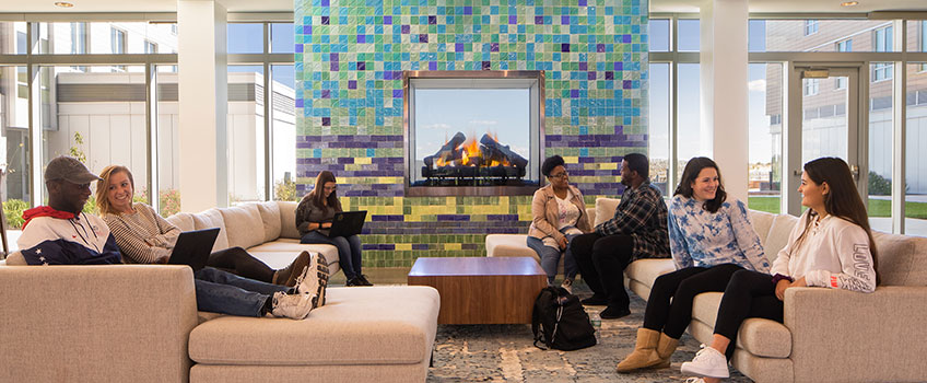 students sitting by the fireplace