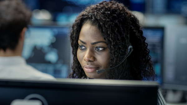 Image of computer support specialist gazing intently at a monitor