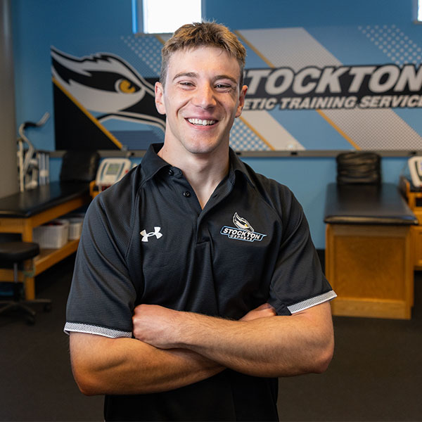 Spencer Campbell '26 stands with his arms folded in the Athletic Training Room.