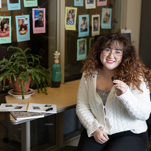 Gabriela Marroquin Bednarska sits at a desk holding a microphone.