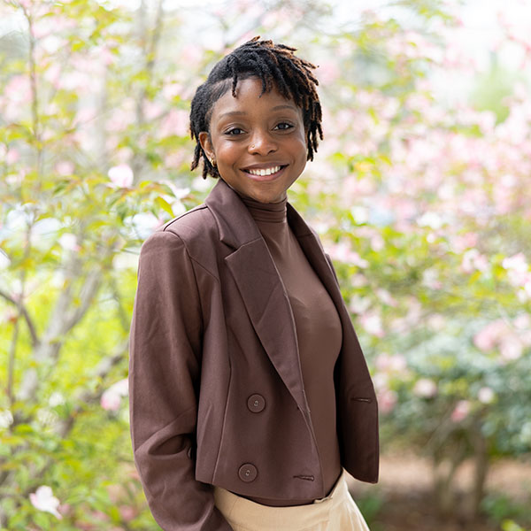 Ashanae Morrison '26 stands in front of a tree on campus