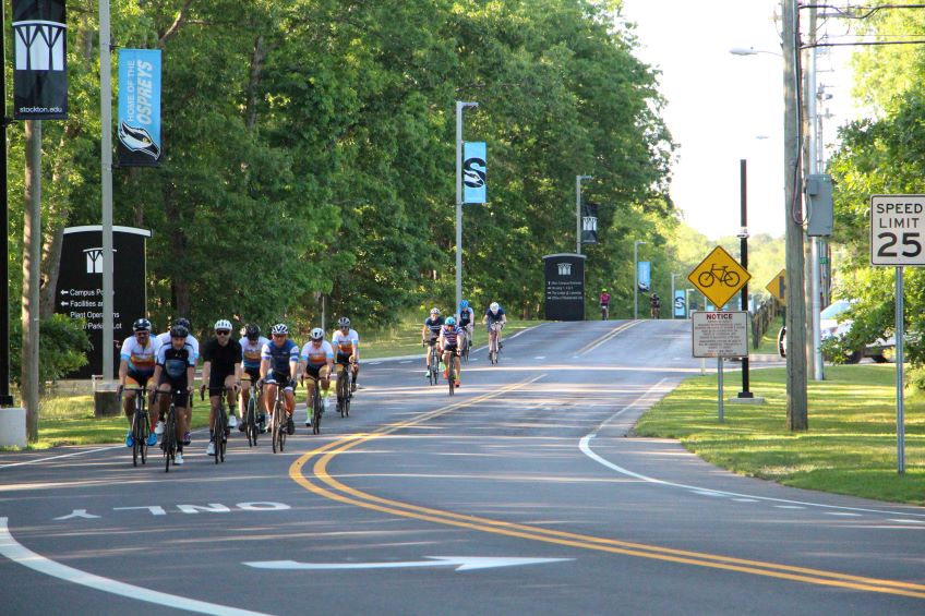 Biker riders, riding through Stockton's campus