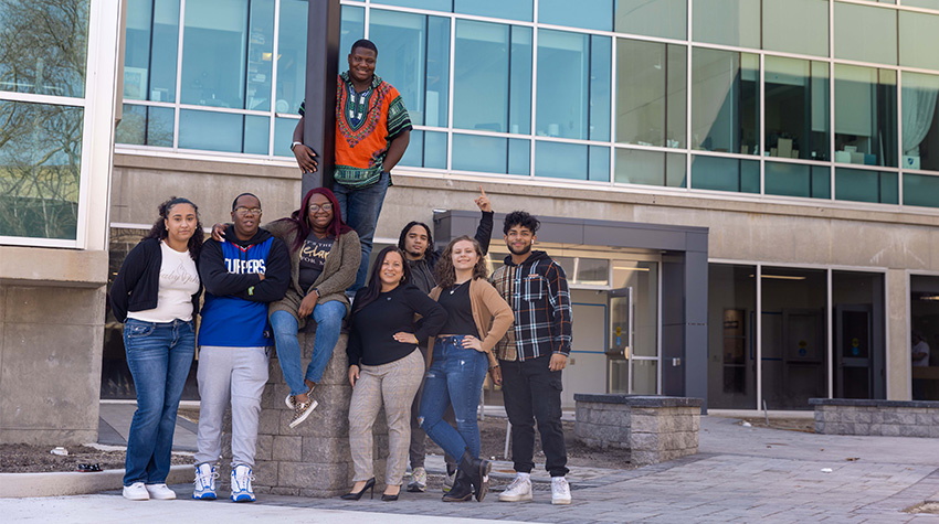 Jovin and students outside of the Multicultural Center