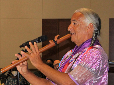 Kevin Locke playing an instrument during Unity Day