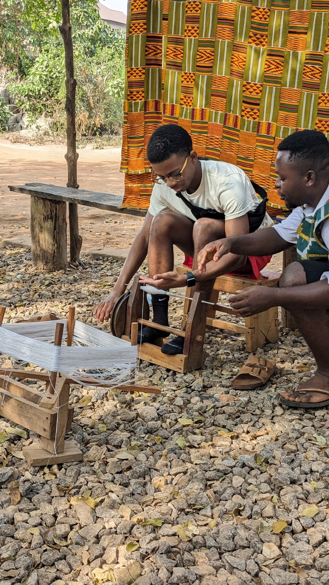Student learning how to weave outdoors in Ghana.