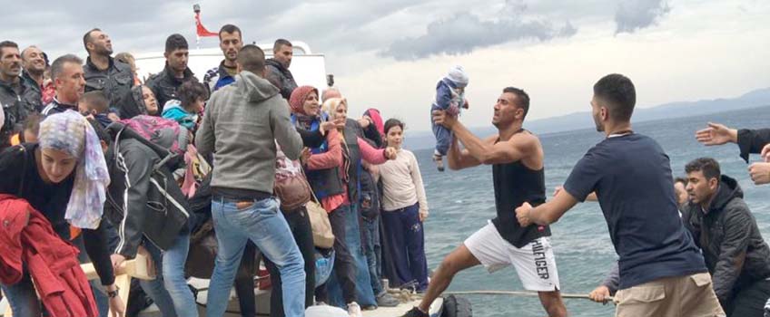 Refugees getting on a boat to safety
