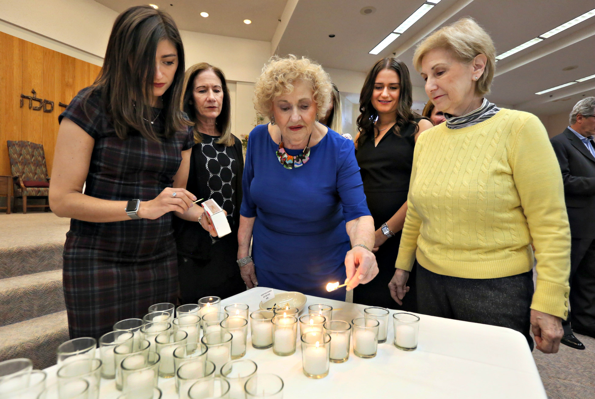 Holocaust survivor Laura Oberlender lighting candles during the 2019 Yom HaShoah Remembrance commemoration. 