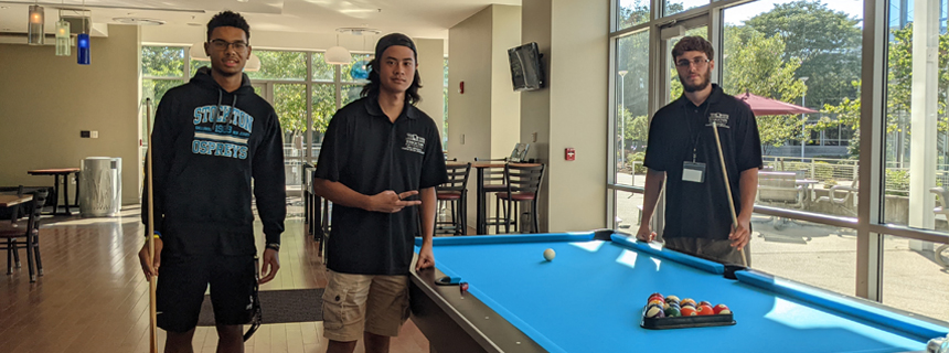 Student training playing pool in the game room Student training playing pool in the game room