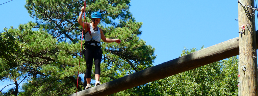 Student participating in the ropes course during training Student participating in the ropes course during training