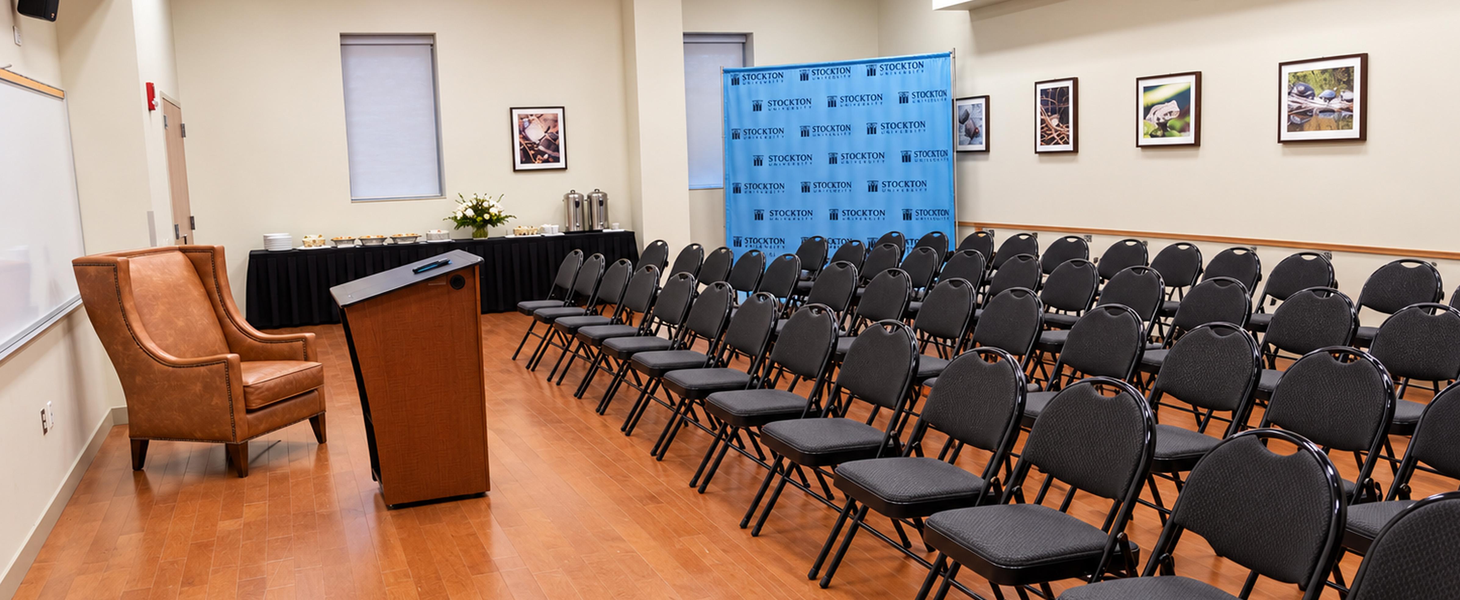 Campus Center Meeting Room 5 set with lecture, podium and step and repeat