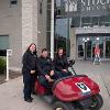 Cpt. Kelly Warantz, Mike Clancy, Brittney Bouchard in golf cart during welcome week