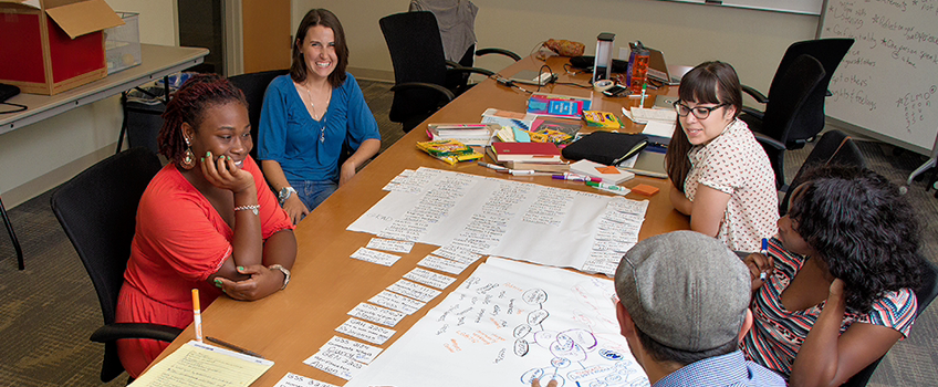Service learning students meeting in a classroom Service learning students meeting in a classroom
