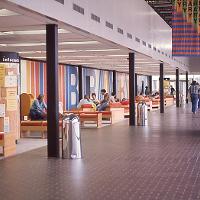 The gallery outside of the library in the 1970s. Notice no coffee bar and no F-wing atrium (the F-wing overbuild with new classrooms and atrium would not be built until the 2000s).