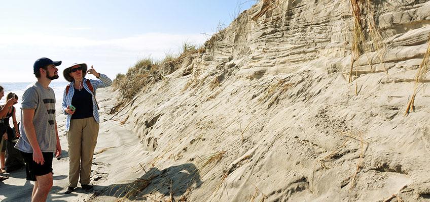 Examining eroded dune face, Pullen Island, NJ. Examining eroded dune face, Pullen Island, NJ.