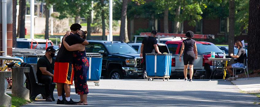 student and mother hugging student and mother hugging