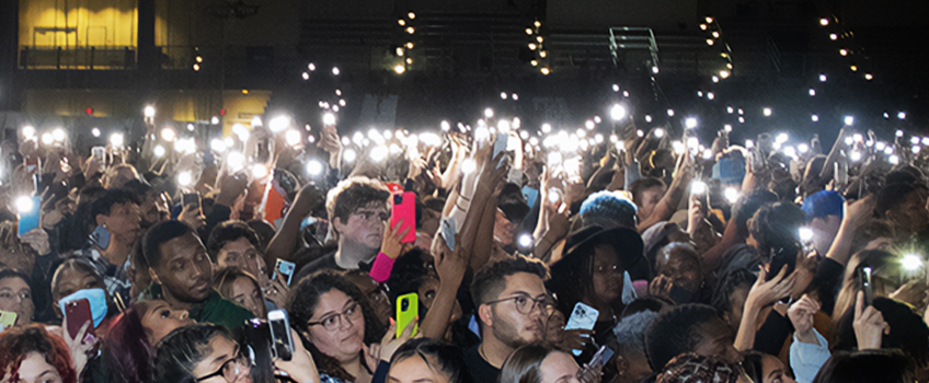 Students with cell phone lights at a Woodstockton concert Students with cell phone lights at a Woodstockton concert