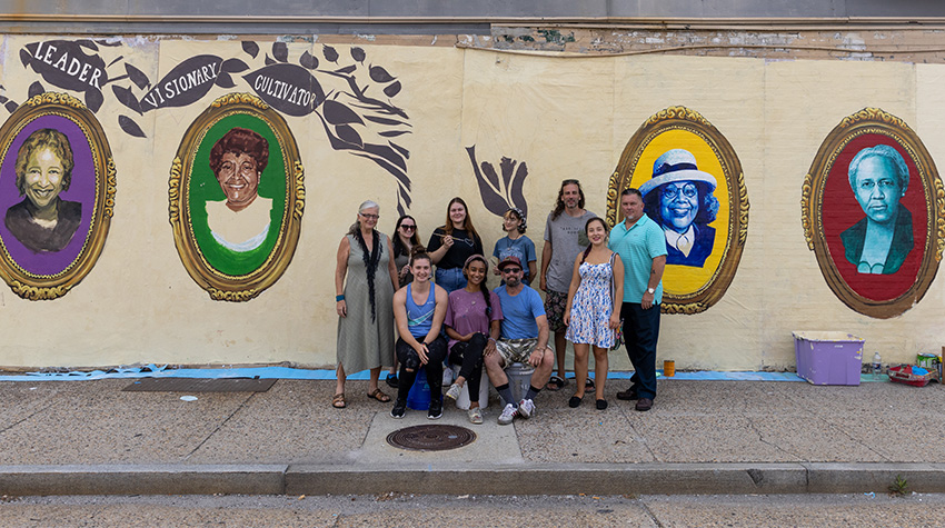 Artists and students in front of one of the murals in AC Artists and students in front of one of the murals in AC