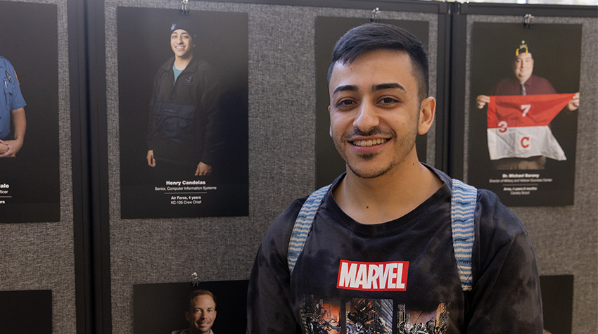 Student vet in front of his portrait Student vet in front of his portrait