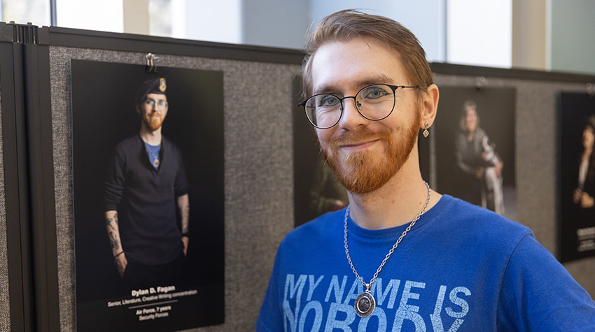 Student vet in front of his portrait Student vet in front of his portrait