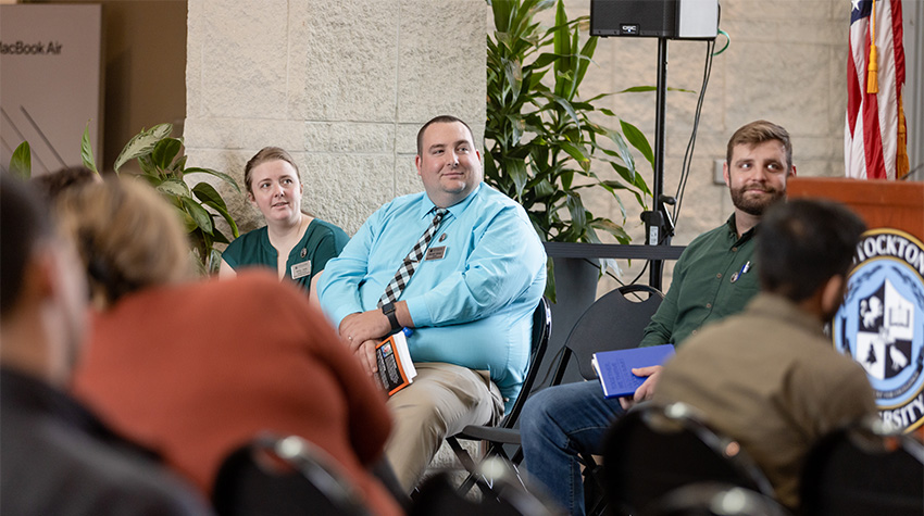 Ashley Jones and Michael Barany of the MVSC with Luke, listening to a speaker Ashley Jones and Michael Barany of the MVSC with Luke, listening to a speaker