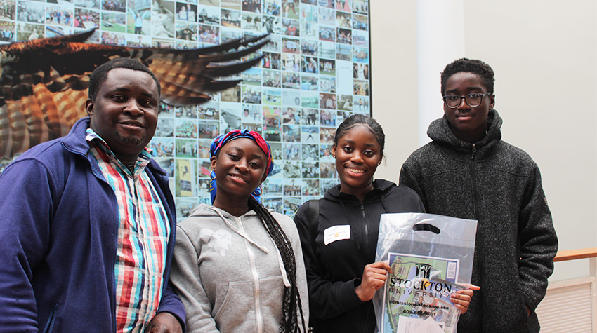 A family in the Campus Center, in front of the mural. A family in the Campus Center, in front of the mural.
