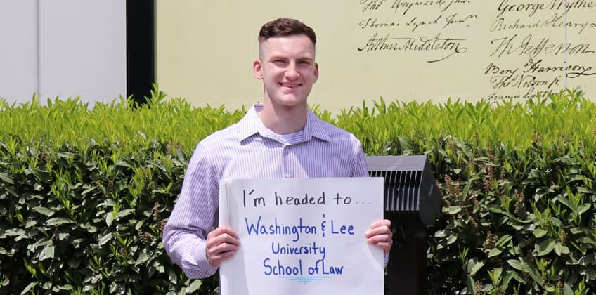 Daniel Theyn holding sign, "I'm headed to Washington & Lee University School of Law" Daniel Theyn holding sign, "I'm headed to Washington & Lee University School of Law"