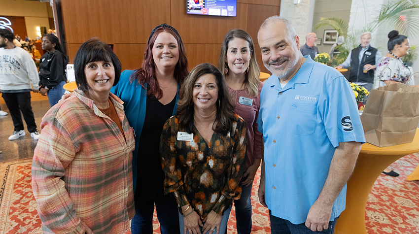 Staff members posing for a photo with President Joe at the Autumn Jam. Photos by Susan Allen.  Staff members posing for a photo with President Joe at the Autumn Jam. Photos by Susan Allen.
