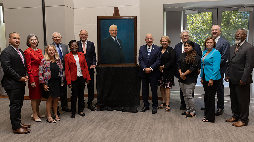 President Emeritus Harvey Kesselman with cabinet members, posing with his portrait President Emeritus Harvey Kesselman with cabinet members, posing with his portrait