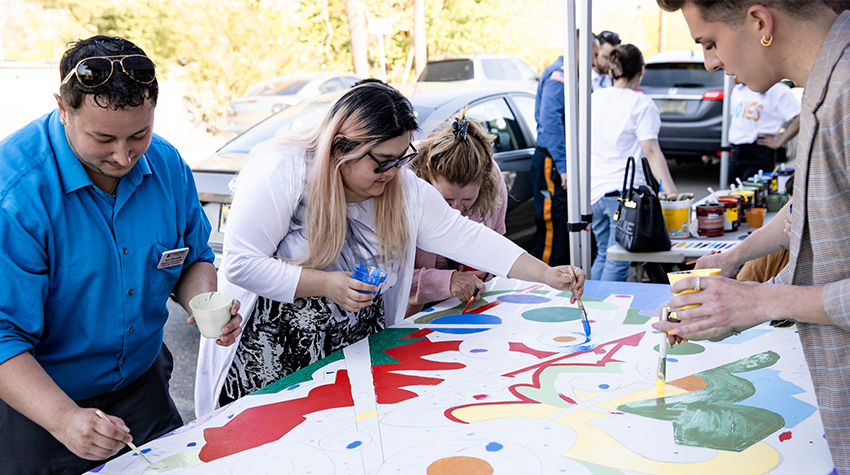 Participants completing a large paint-by-numbers activity during Kramer Hall's celebration Participants completing a large paint-by-numbers activity during Kramer Hall's celebration