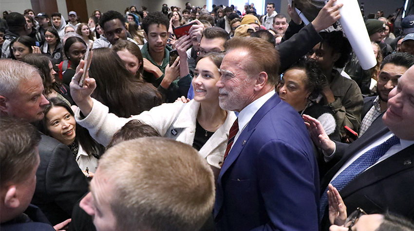 Arnold with students, taking a selfie with one Arnold with students, taking a selfie with one