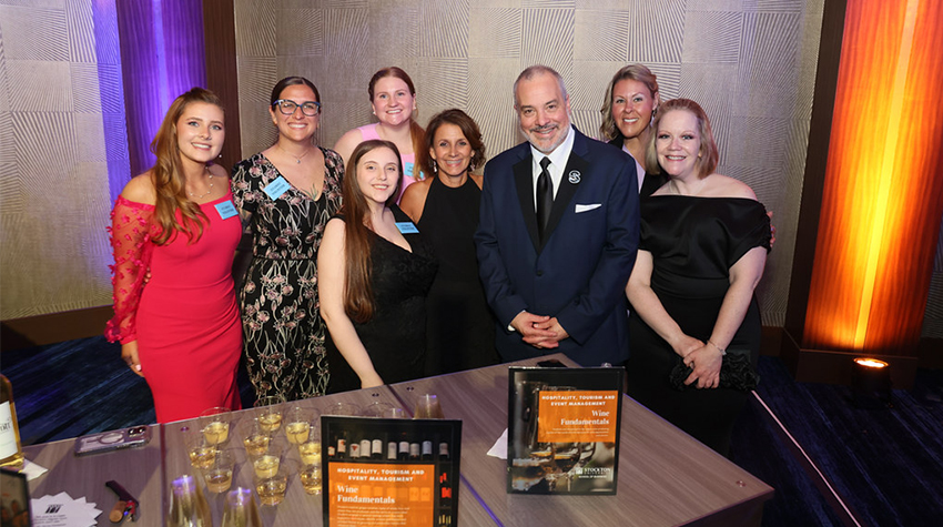 President Joe posing for a photo with wine/hospitality class students President Joe posing for a photo with wine/hospitality class students