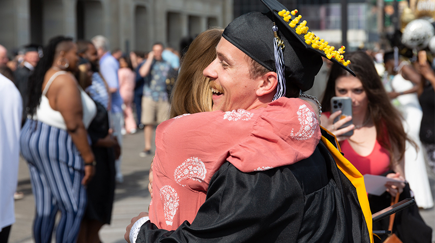 A student hugging his mom after Commencement A student hugging his mom after Commencement