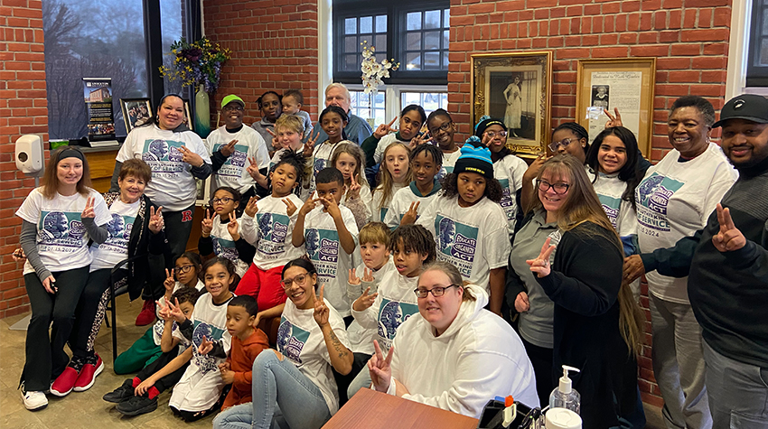 Students posing for a photo during a project Students posing for a photo during a project