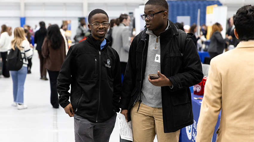 Students dressed to impress with resumes in hand for the Career Fair Students dressed to impress with resumes in hand for the Career Fair