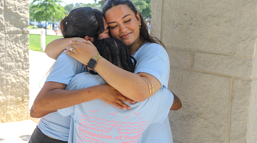 Three EOF alumni in a warm embrace Three EOF alumni in a warm embrace