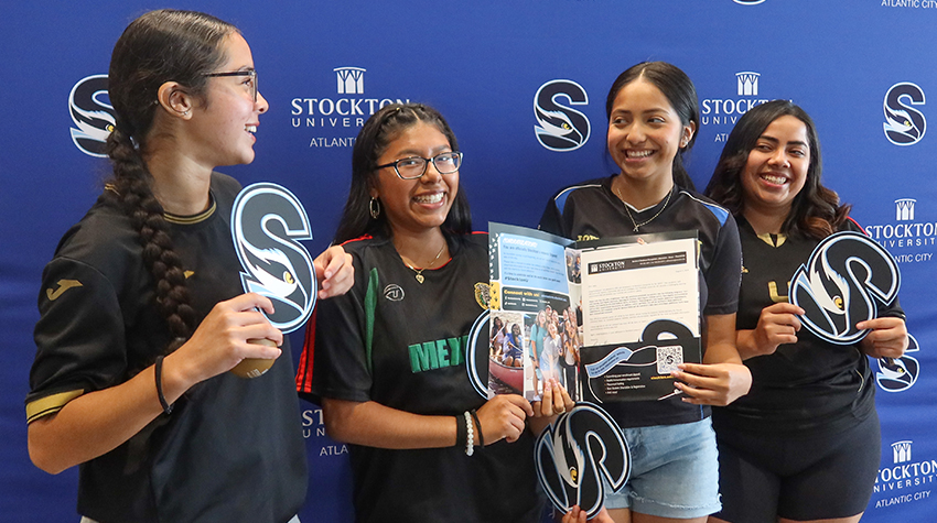 A student laughing with her friends after receiving an acceptance letter to Stockton A student laughing with her friends after receiving an acceptance letter to Stockton