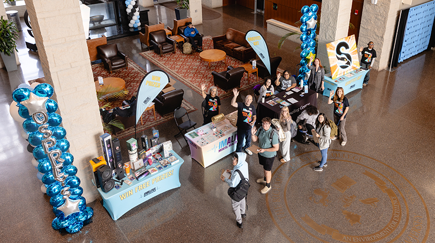 IMALIVE volunteers and students took a photo during a quiet moment of the fair. IMALIVE volunteers and students took a photo during a quiet moment of the fair.