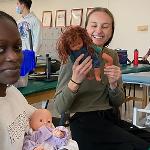 Students with therapy dolls.