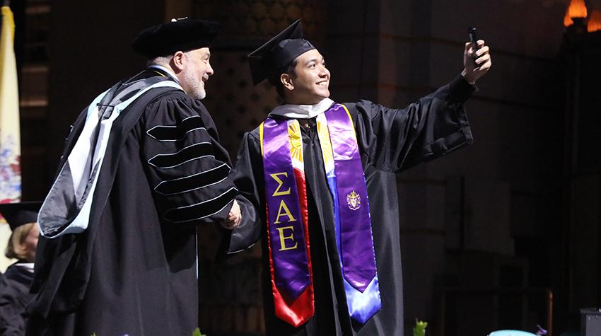 A student took a selfie with President Joe on stage A student took a selfie with President Joe on stage