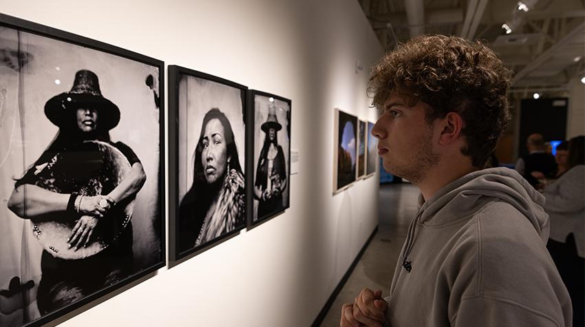 A student looking at one of the displayed photos A student looking at one of the displayed photos