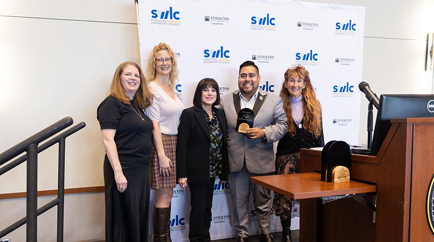 Irvin Moreno Rodriguez receiving the SWLC Legacy Award on behalf of Gail Rosenthal Irvin Moreno Rodriguez receiving the SWLC Legacy Award on behalf of Gail Rosenthal