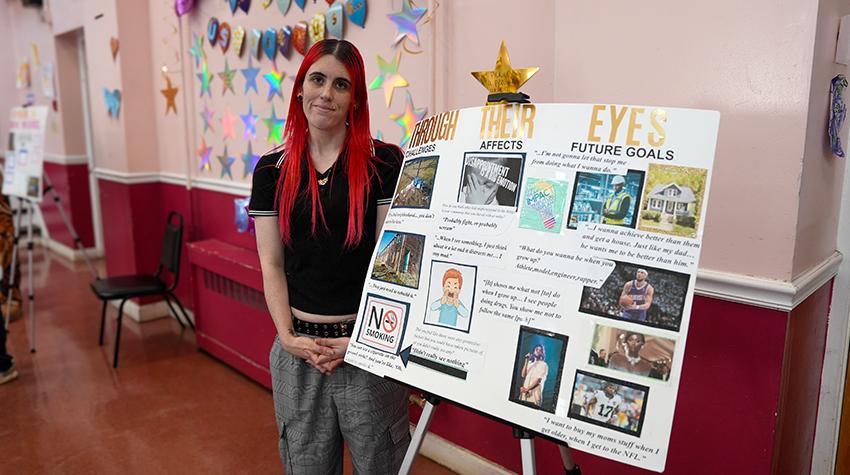 One of Scott's students in front of one of the displays One of Scott's students in front of one of the displays