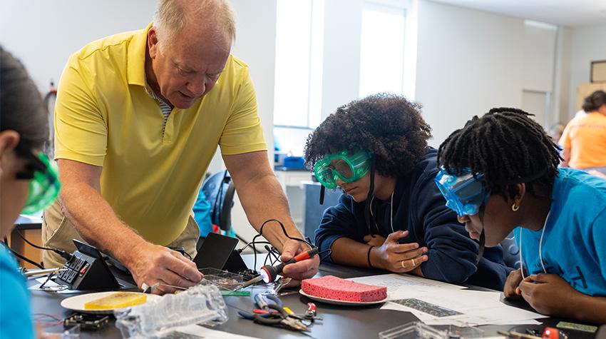 Tech Trek participants soldering circuit boards Tech Trek participants soldering circuit boards