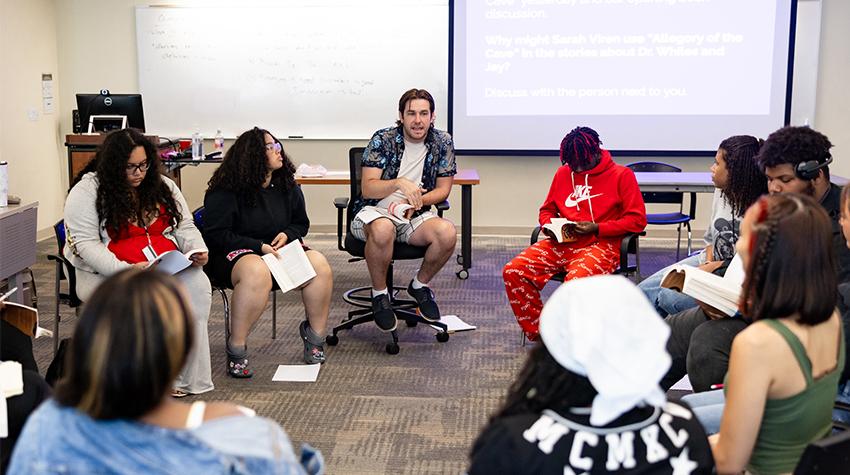 EOF students and a professor talking in a circle EOF students and a professor talking in a circle