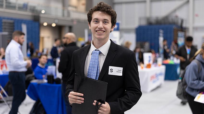 A student, nicely dressed, holding a resume A student, nicely dressed, holding a resume