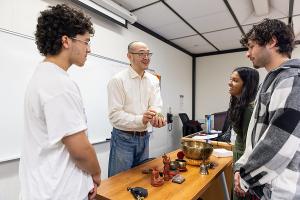 Students explore world religions through hands-on learning with artifacts and discussion led by Philosophy and Religion faculty.