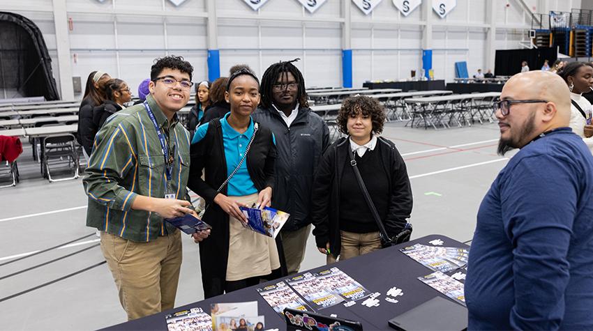 Students posting for a photo at the EOF table Students posting for a photo at the EOF table